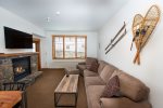 The cozy living room features a queen sleeper sofa, gas fireplace & walkout patio with direct access to the slopes.